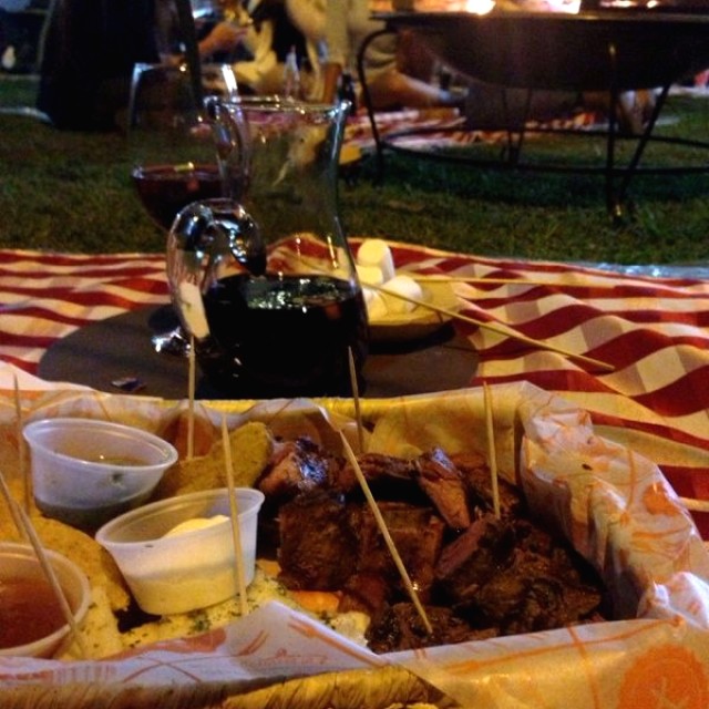 Picada de porción de solomito, costilla, chorizo argentino, papa rustica, arepa y salsas, media jarra de sangria tinto, y malvaviscos