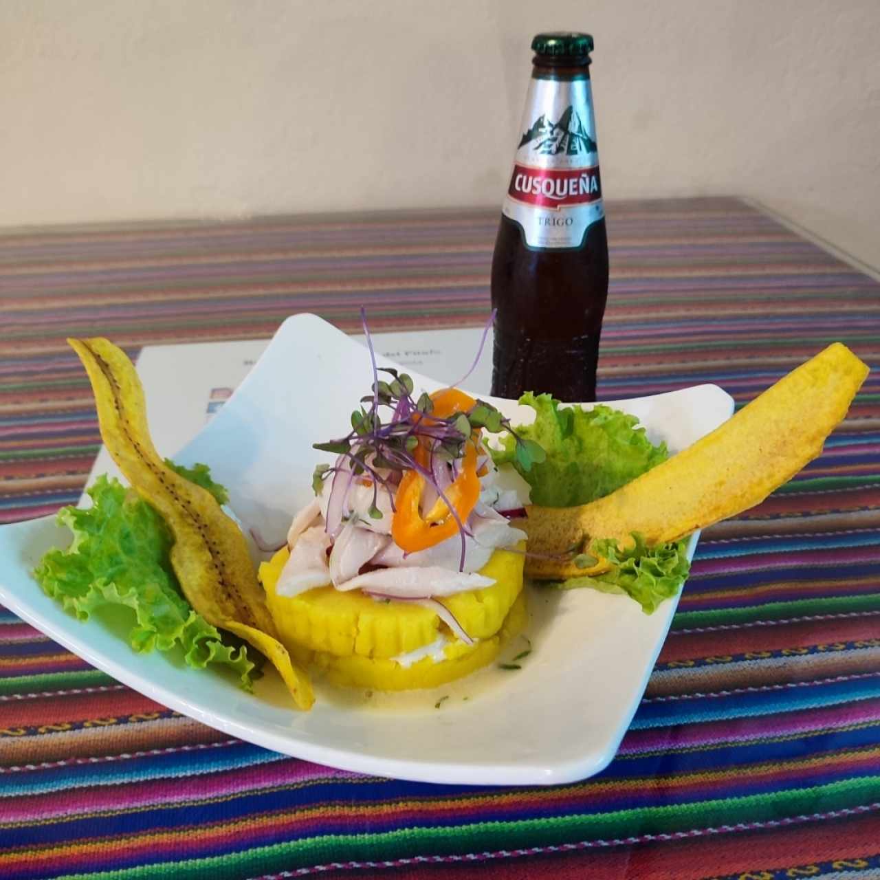 causa limeña coronada con ceviche corvina