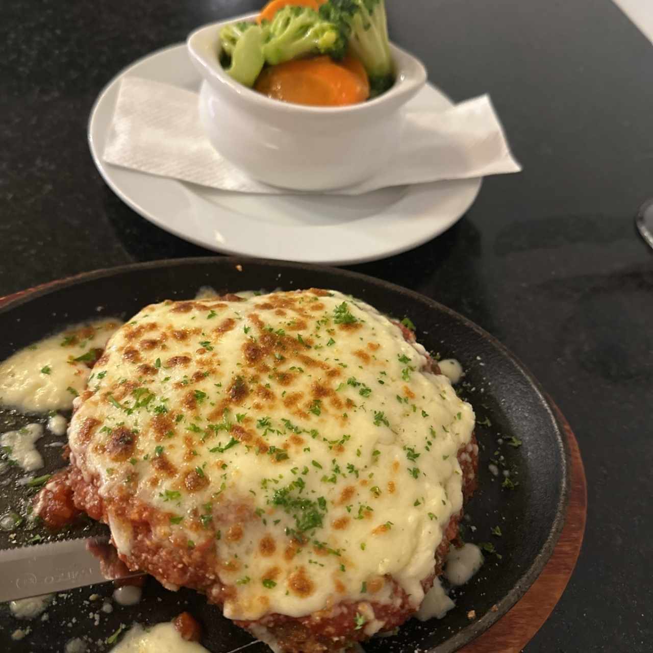 Milanesa de res a la parmesana con vegetales salteados 