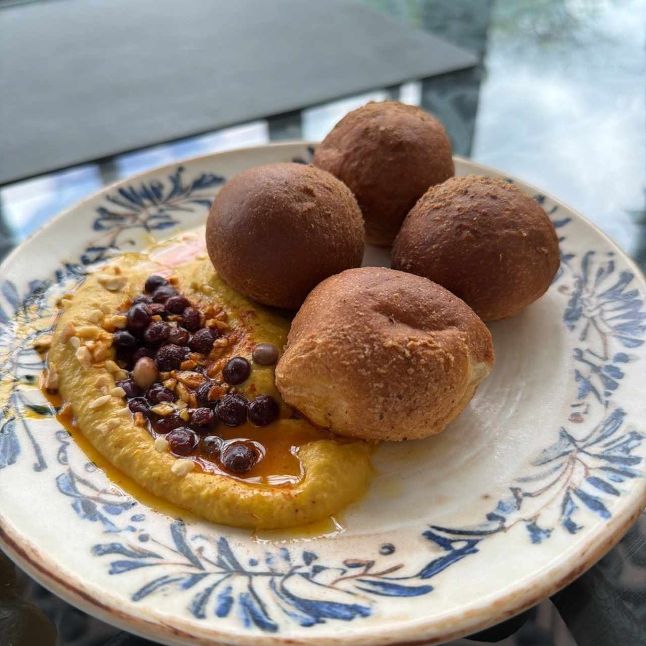Pan de la casa con nibs de cacao y almendra con hummus con mani, paprika y guandú encurtido
