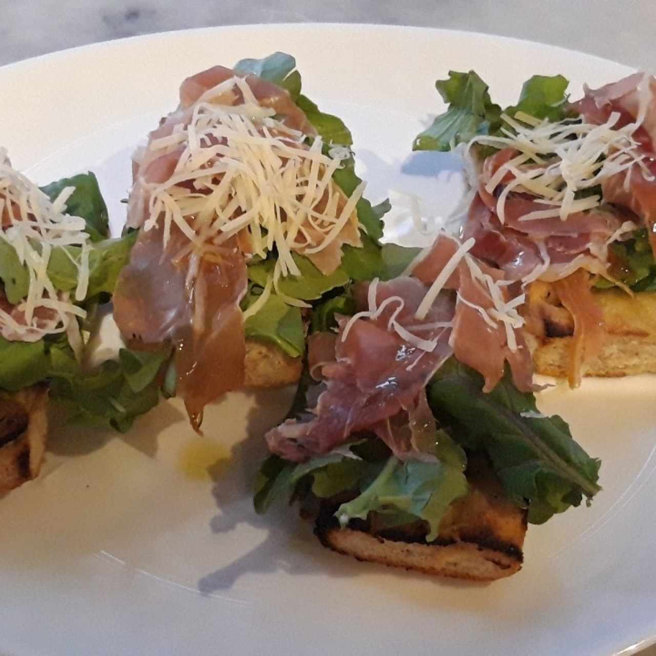 entrada de prosciutto con arugula