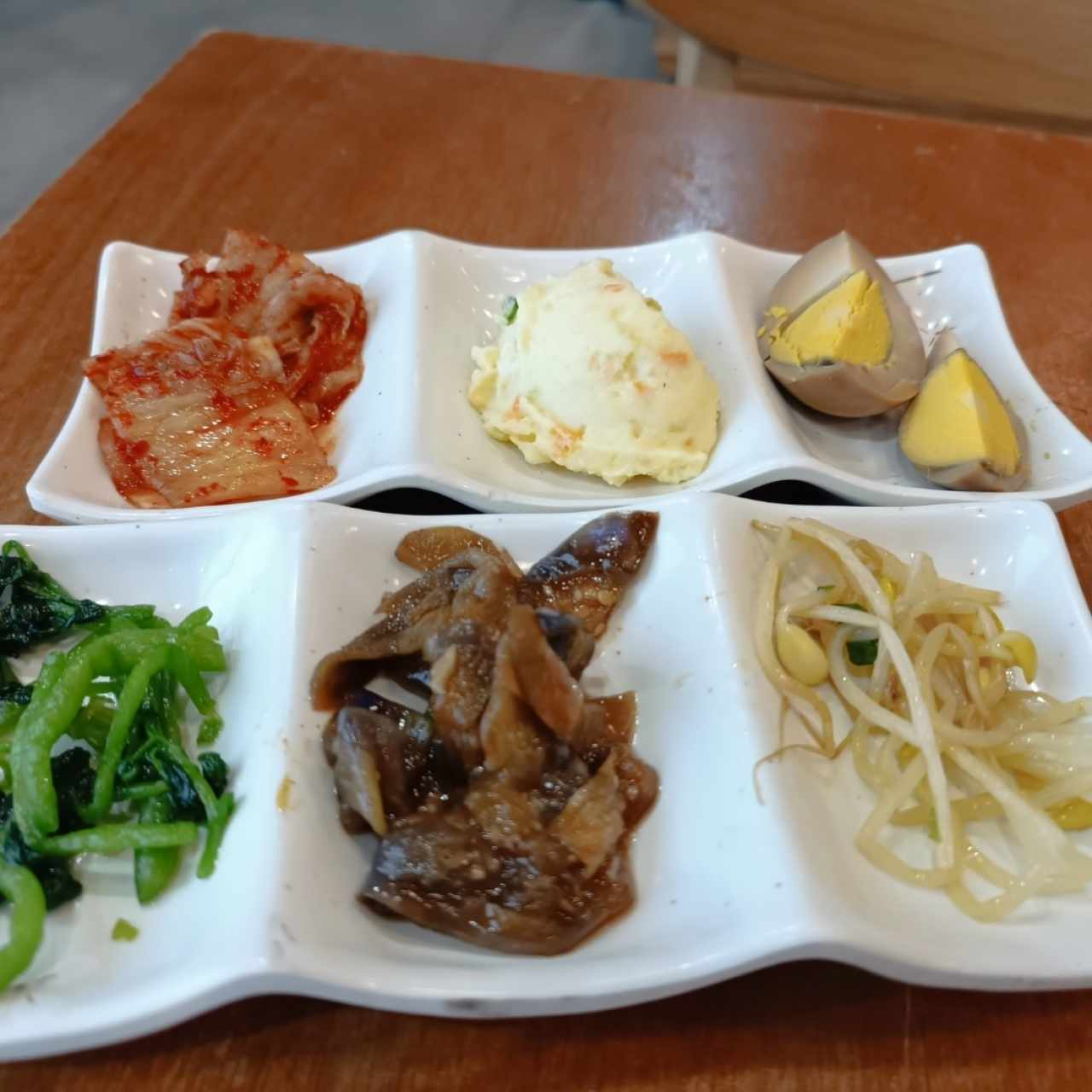 acompañantes de guarnición, el primero desde la izquierda en la fila superior es el kimchi....una maravilla.