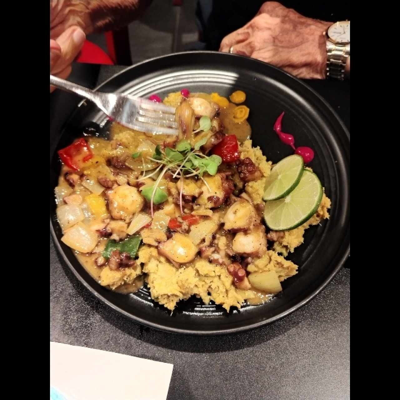 Pulpo al estilo afroantillano a base de coco, curry y jengibre, sobre mangú y brotes de cilantro