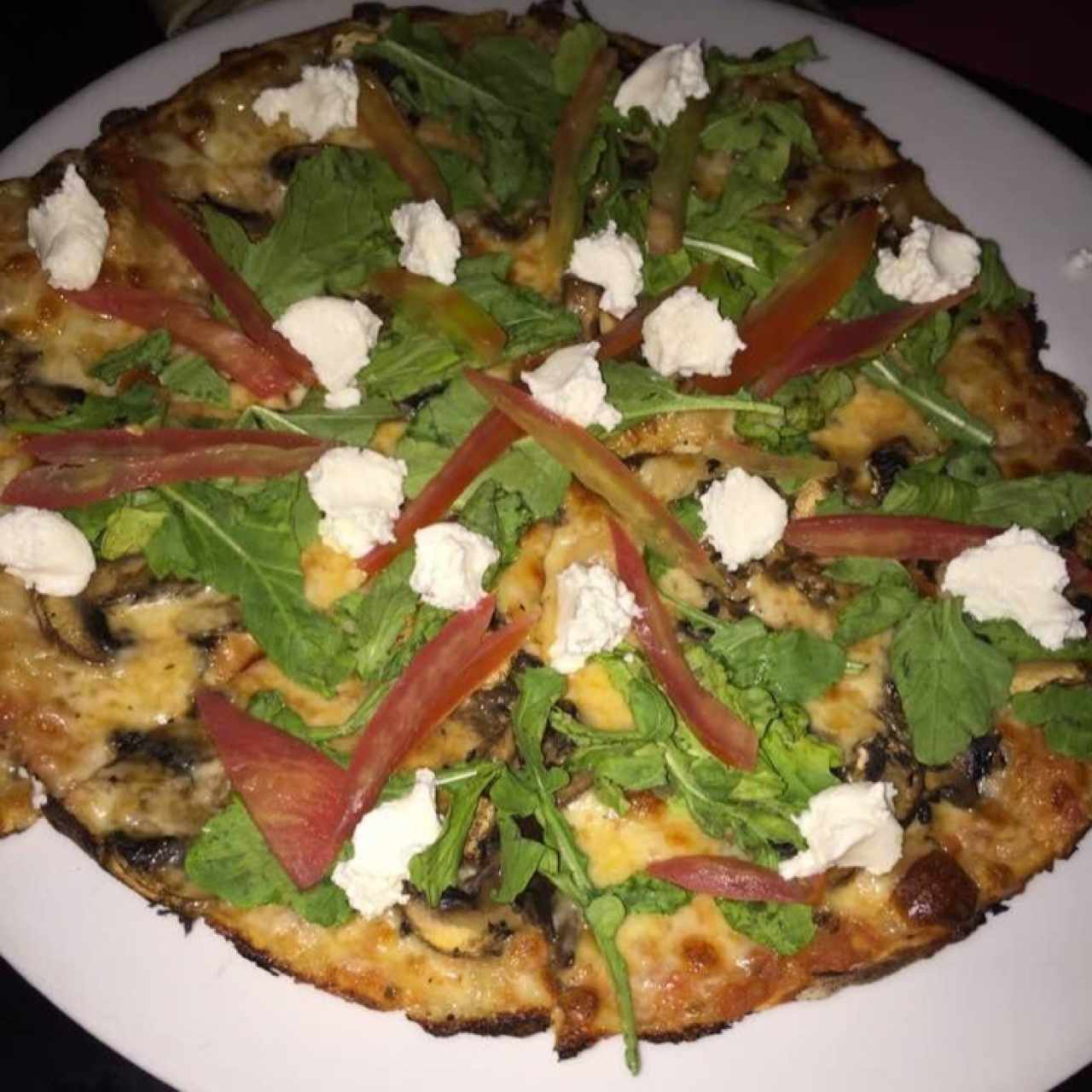 Ddliciosa pizza con rúgula, queso de cabra y tomate