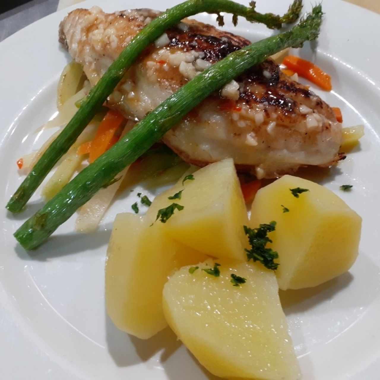 mero  en cama de vegetales con espárragos 