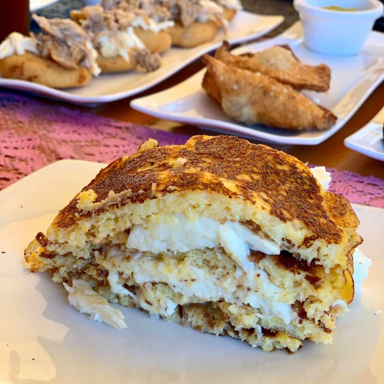 Cachapa con queso... al fondo, pastelitos andinos y por allááá arepitas de chicharron con con topping de pernil y queso 🤤