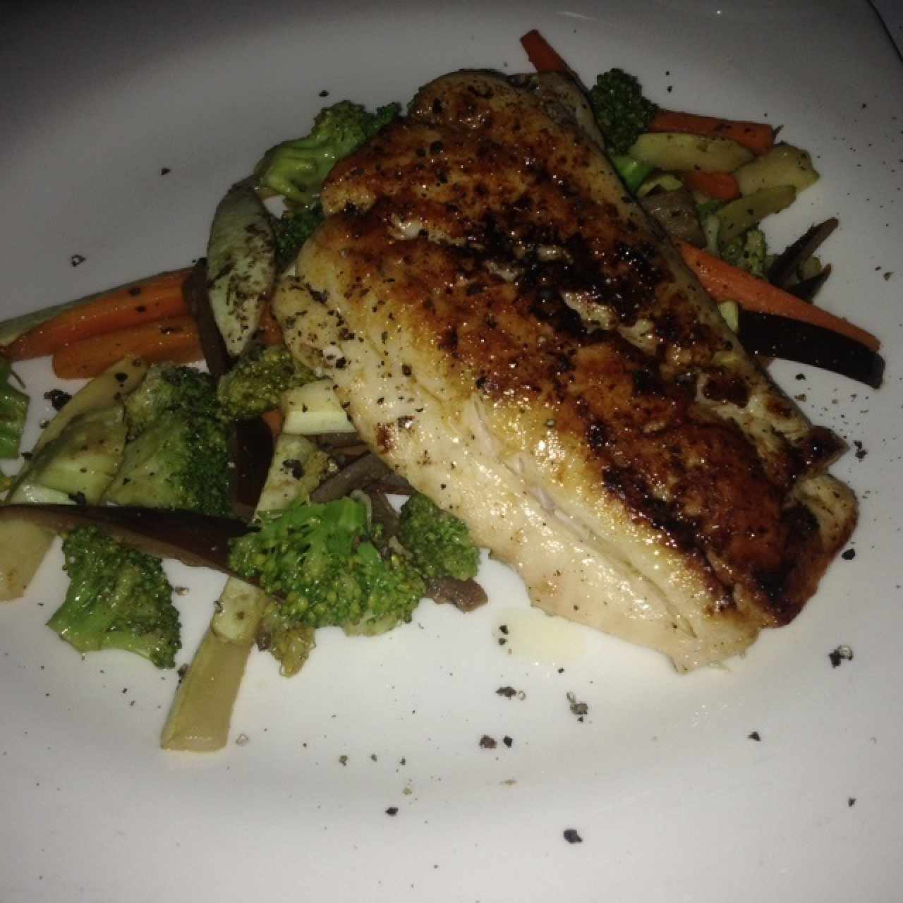 pescado del día en cama de vegetales
