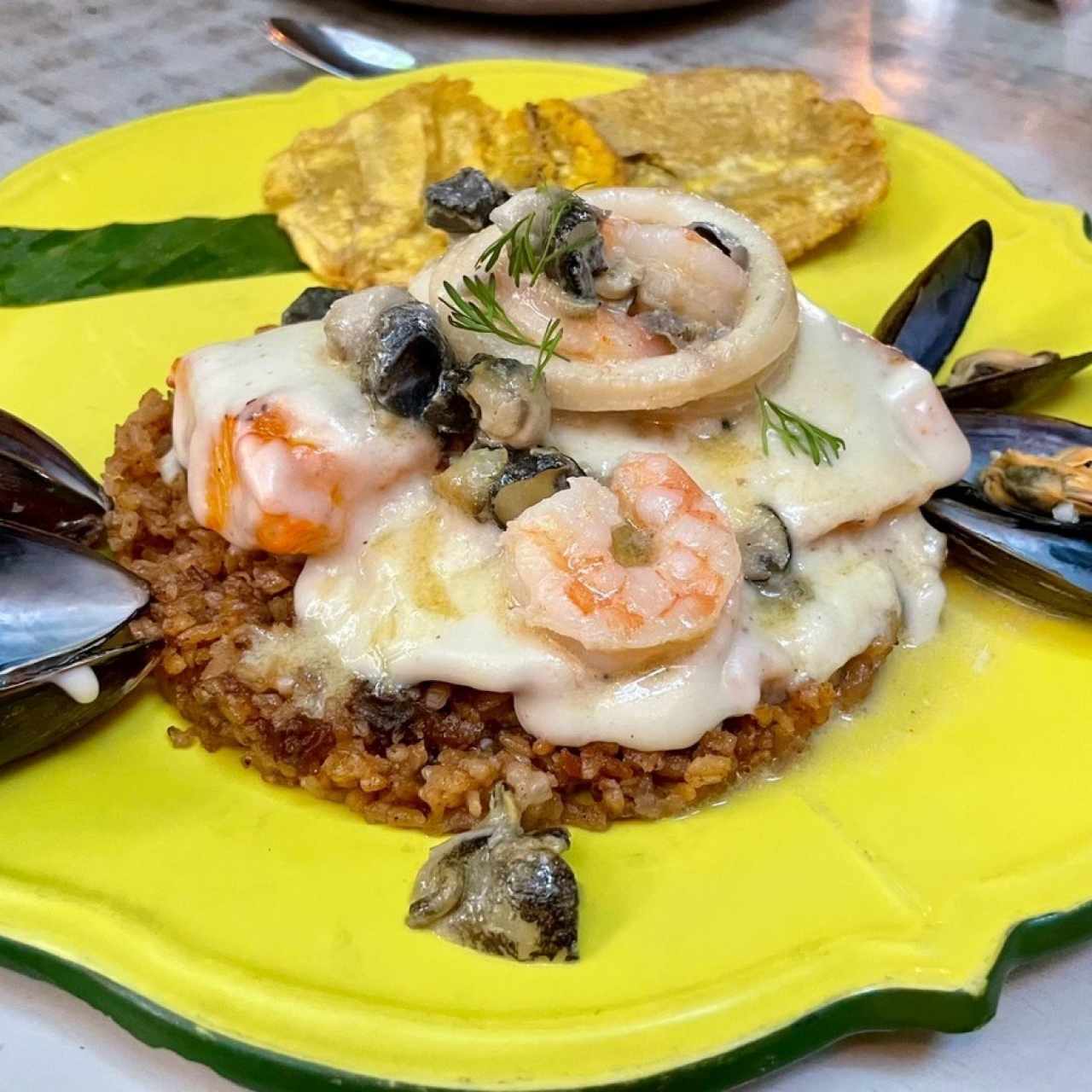 FILETE DE PESCADO DE LA NEGRA CANDÉ (Filete de Pescado Fresco de Temporada a la Parrilla con Salsa Cartagenera - Tres Esquinas [Cartagenero], Camarones, Calamares, Caracol y Mejillones; acompañado de Arroz de Coco Negro y Patacones)