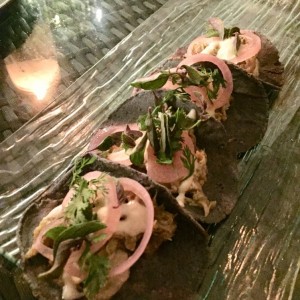 Tacos de cerdo en adobo verde cocido bajo tierra
