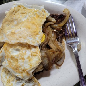 Bistec encebollado y huevo frito