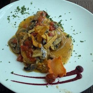 Medio pollo al ajillo con hongos.