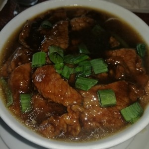 Sopa de carne con hojas de mostaza.