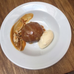 Dona con salsa de arequipe, helado de vainilla y crujientes de coco