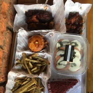 papas rusticas, dados de panza de cochino, costilla de cerdo, ensalada capresa y una porcion de red velvet 