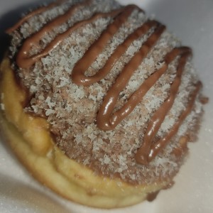 Dona rellena de nucita con topping de coco y nucita 