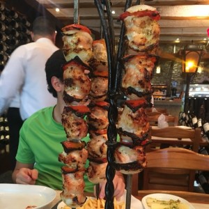 brocheta de pollo con racion de yuca y papas fritas